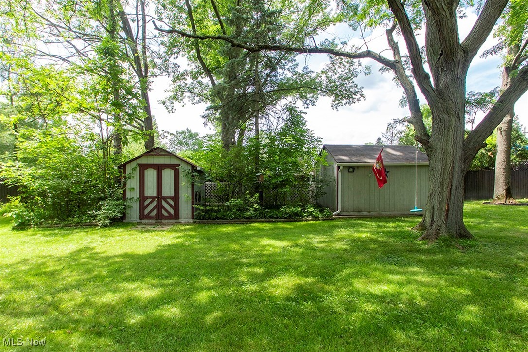 20749 Albion Road Strongsville, OH 44149 - Photo 33 of 35 View of yard with an outbuilding, a storage shed, and fence