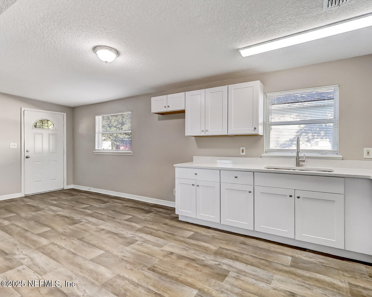 2028 Hartridge Street Jacksonville, FL 32209 - Photo 14 of 33 a kitchen with granite countertop white cabinets and window
