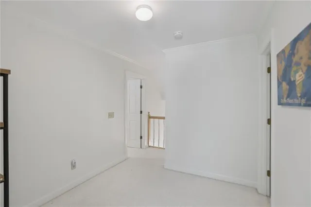 a kitchen with a sink white cabinets and stainless steel appliances