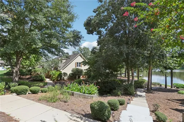 a backyard of a house with a table and chairs