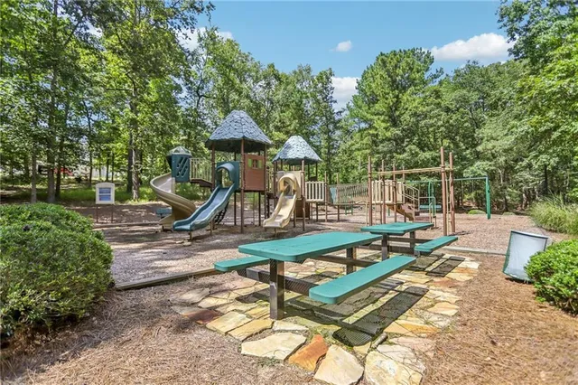 a view of a chair and table in backyard of the house