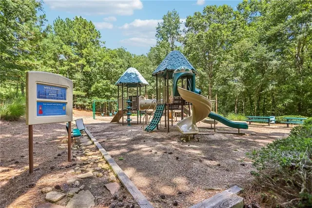 a living room with furniture and floor to ceiling window