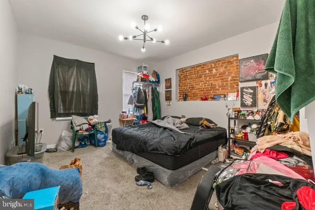 a bedroom with bed and a window