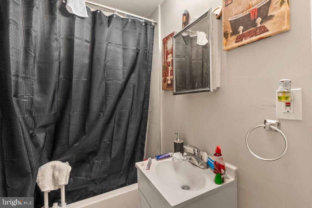 2436 East Preston Street Baltimore, MD 21213 - Photo 20 of 22 a bathroom with a sink toilet and a mirror