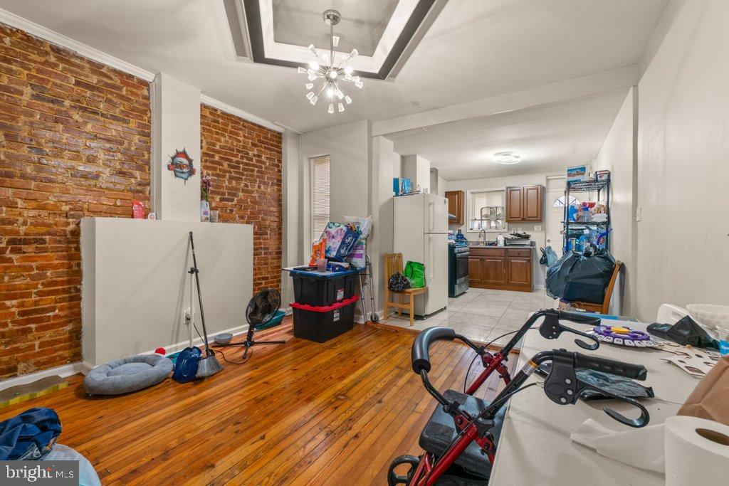 2436 East Preston Street Baltimore, MD 21213 - Photo 7 of 22 a bedroom with bed and a chandelier