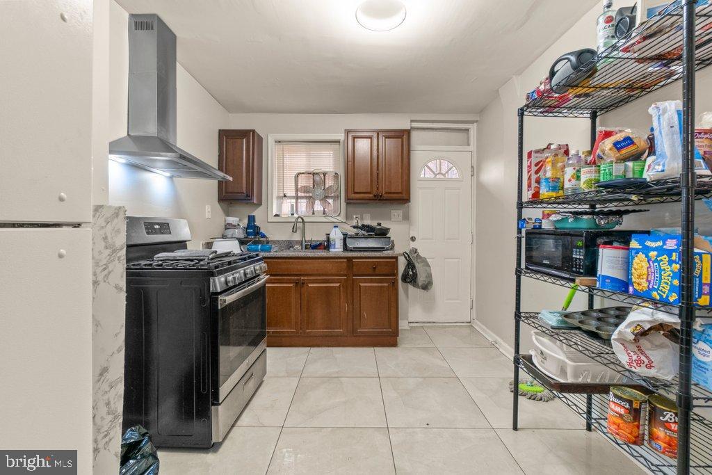 2436 East Preston Street Baltimore, MD 21213 - Photo 9 of 22 a kitchen with a stove top oven and cabinets