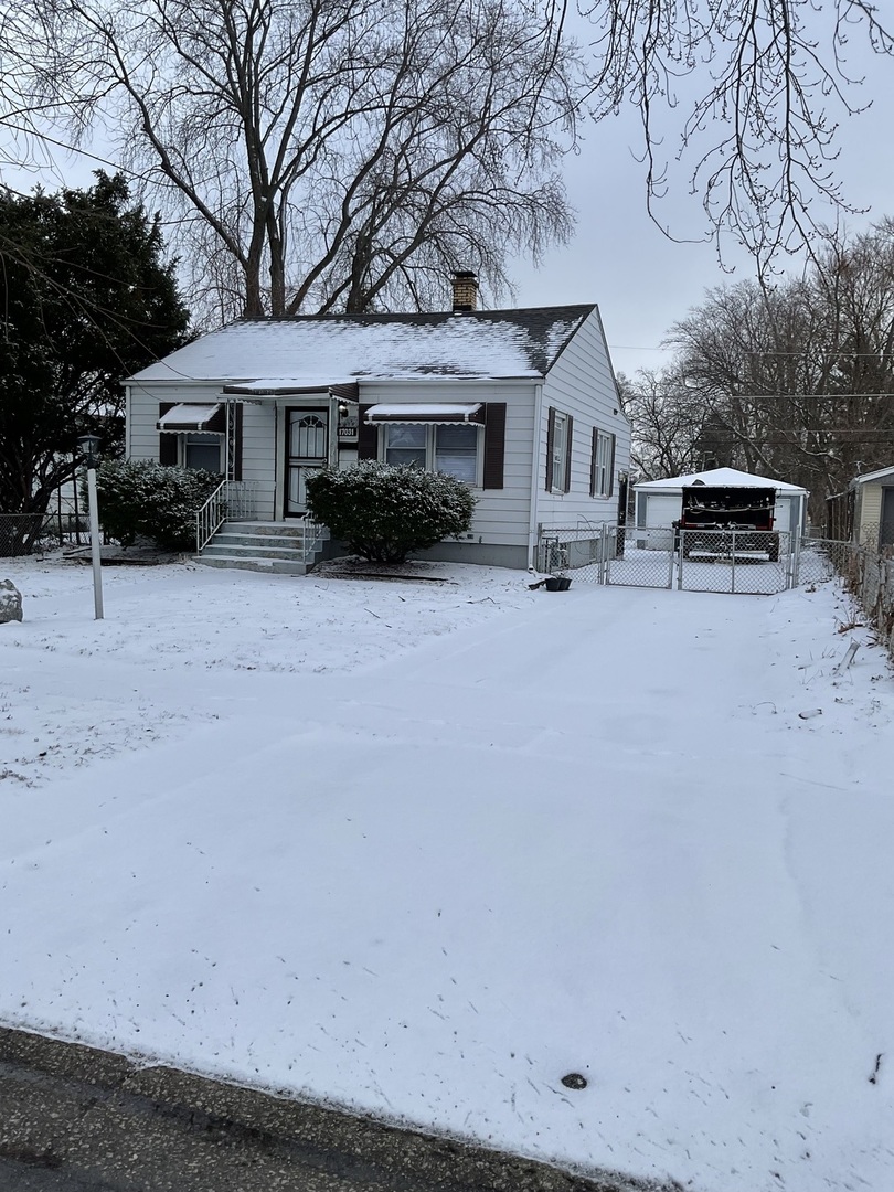 17031 Trapet Avenue Hazel Crest, IL 60429 - Photo 1 of 13 a front view of a house with a yard