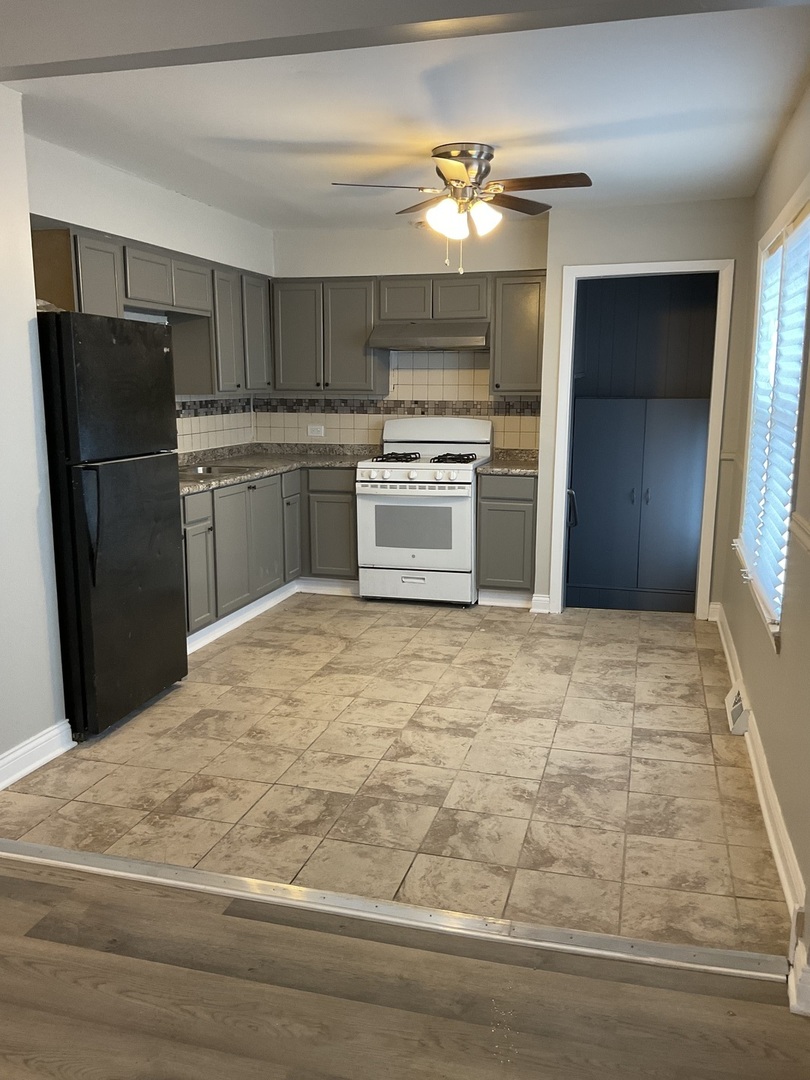 17031 Trapet Avenue Hazel Crest, IL 60429 - Photo 7 of 13 a kitchen with granite countertop a refrigerator and a stove