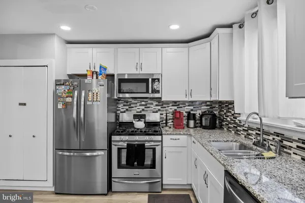 a kitchen with a refrigerator sink and microwave