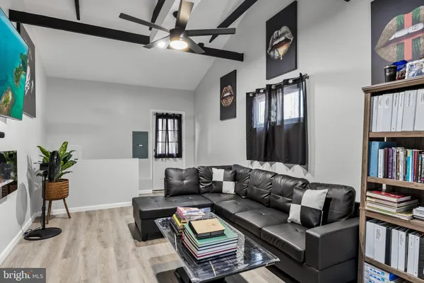 a living room with furniture and a book shelf