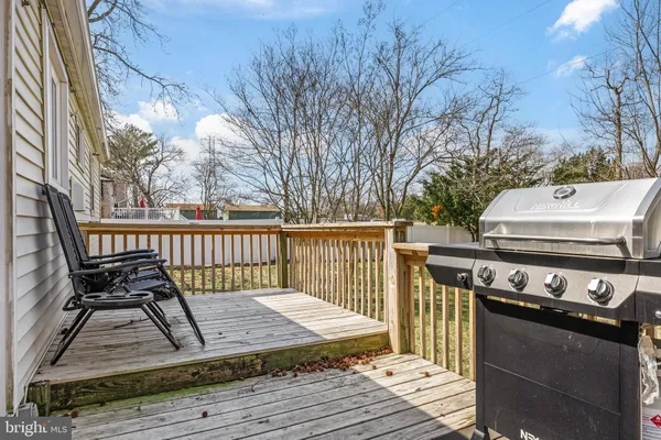 a view of a deck with wooden floor and fence
