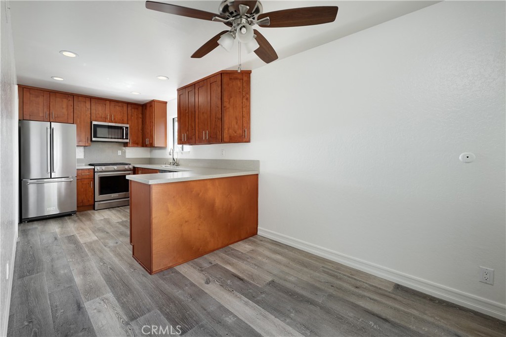 3638 South Main Street, Unit D11 Santa Ana, CA 92707 - Photo 6 of 19 a kitchen with stainless steel appliances granite countertop a stove a refrigerator and a microwave