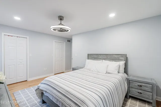 a bedroom with a bed and a ceiling fan
