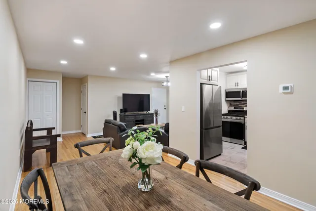 a view of a livingroom with furniture and a flat screen tv