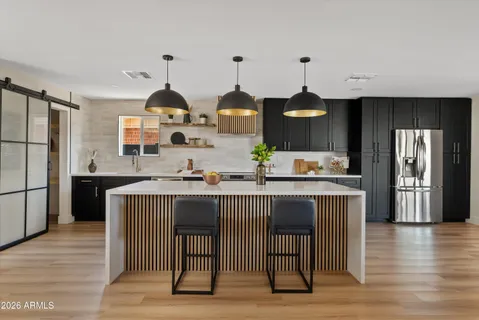 a kitchen with center island table and chairs