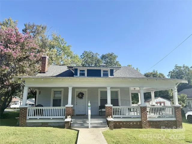 a front view of house with yard outdoor seating and green space