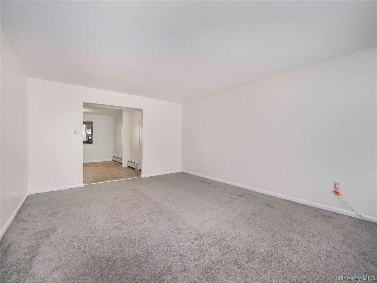 27 Tanager Road, Unit 2702 Monroe, NY 10950 - Photo 17 of 35 Spacious interior room featuring light gray carpeting and white walls