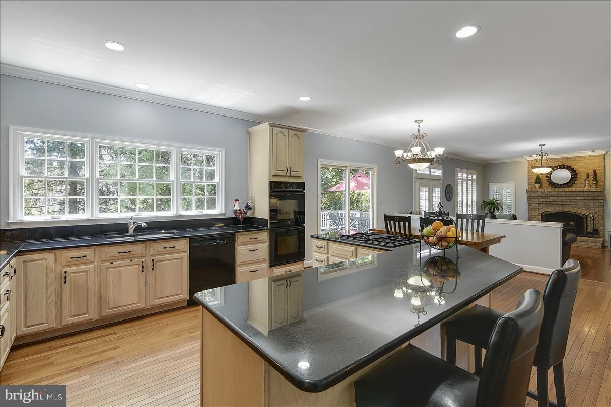 9409 Old Courthouse Road Vienna, VA 22182 - Photo 8 of 30 a kitchen with stainless steel appliances granite countertop a refrigerator a sink a stove a dining table and chairs