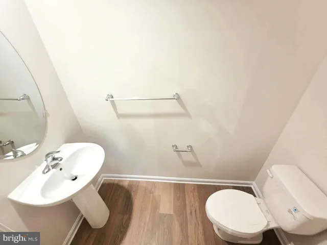 a bathroom with a sink mirror and toilet