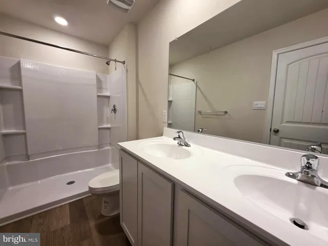 a bathroom with a sink toilet tub and shower