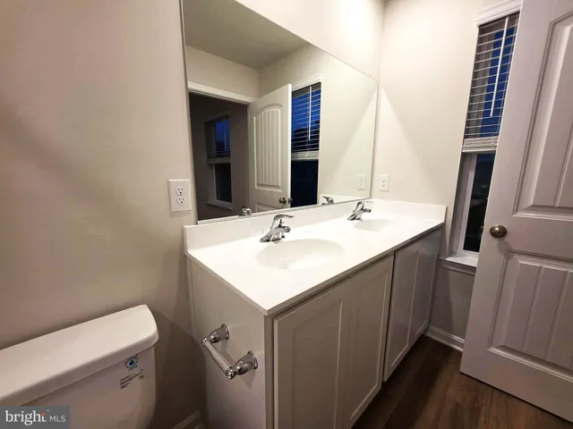 a bathroom with a sink toilet and a mirror