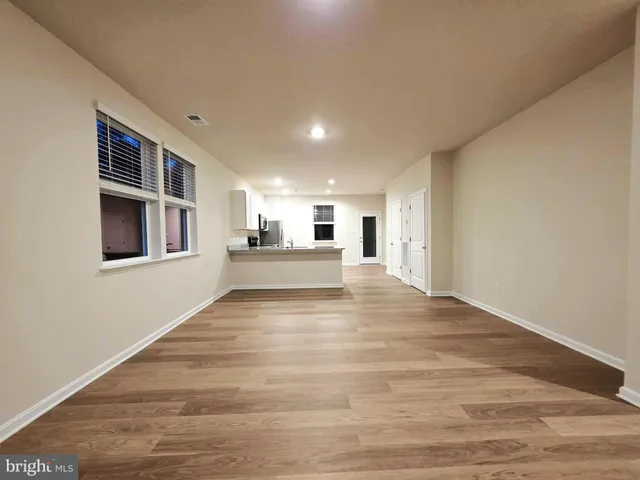 a view of a kitchen with an entryway and wooden floor