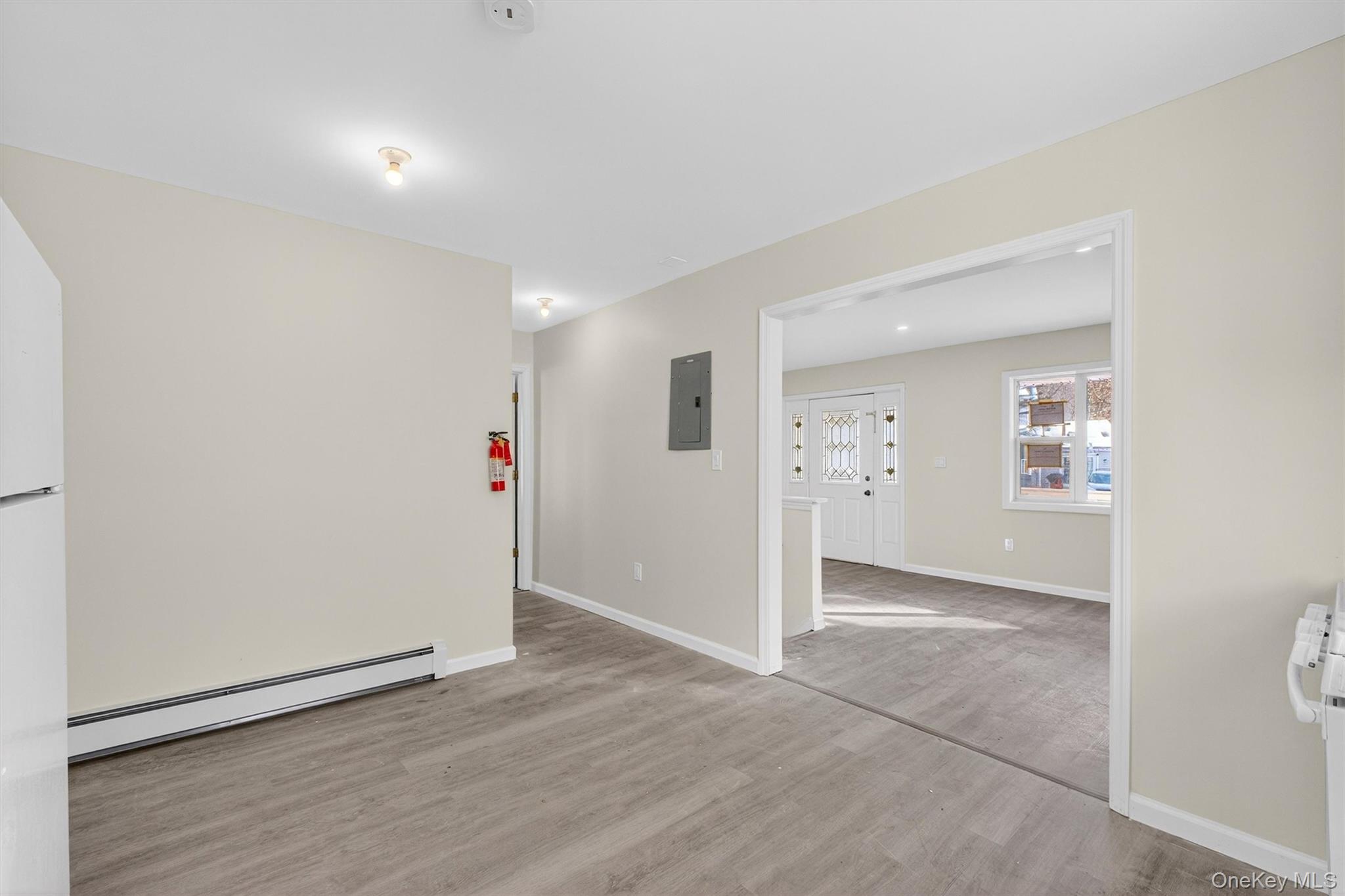 149 Lewis Lane, Unit 1 Wallkill, NY 12589 - Photo 11 of 23 an empty room with wooden floor and entryway