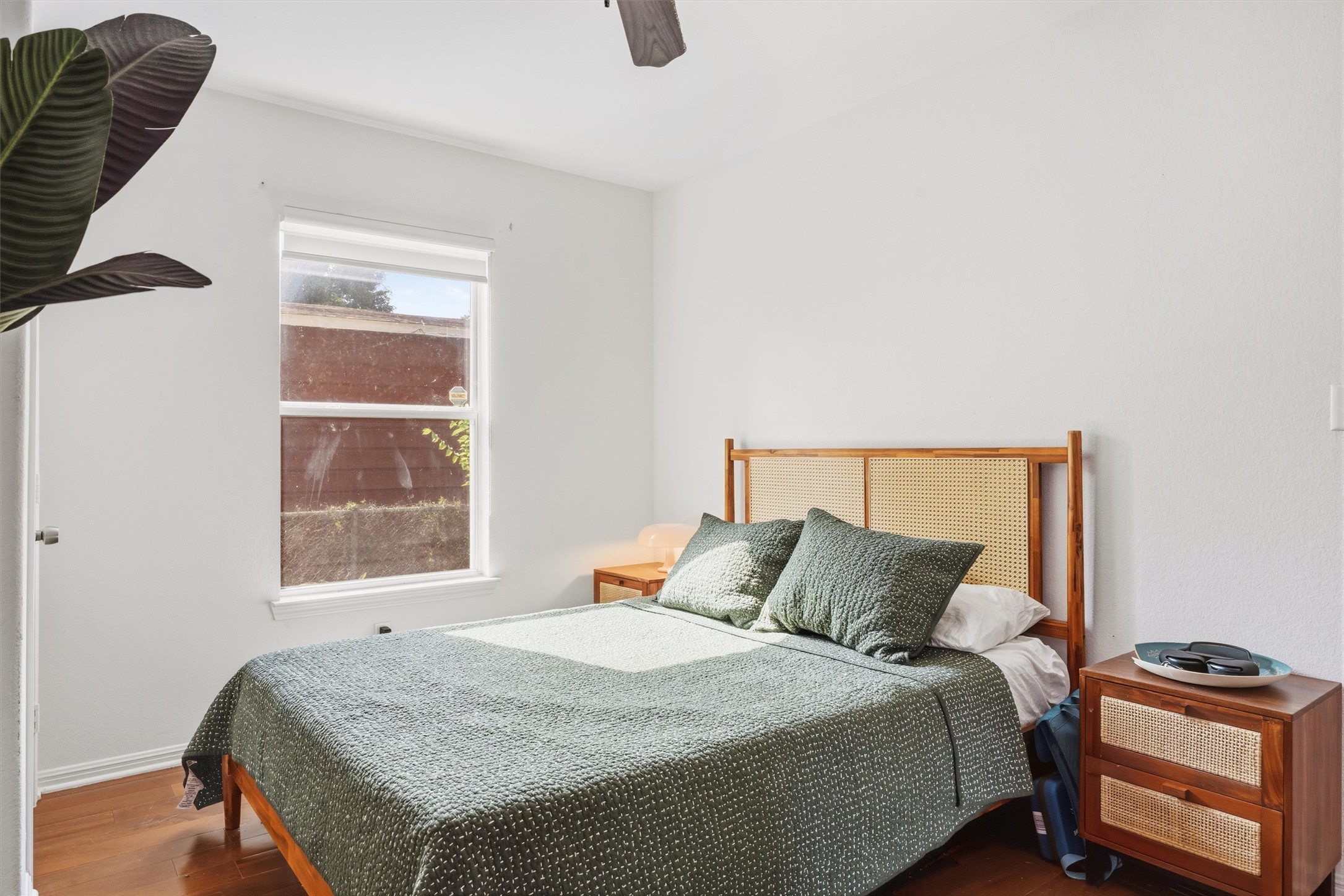 3015 Castro Street Austin, TX 78702 - Photo 20 of 40 Hardwood floors and a bright window elevate this cozy and inviting bedroom.