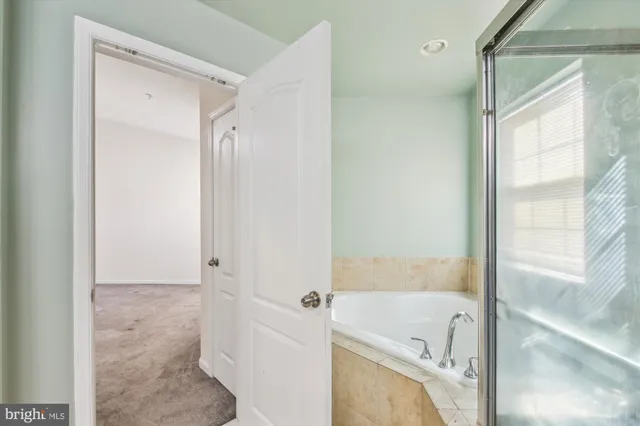 a bathroom with a tub shower and a sink