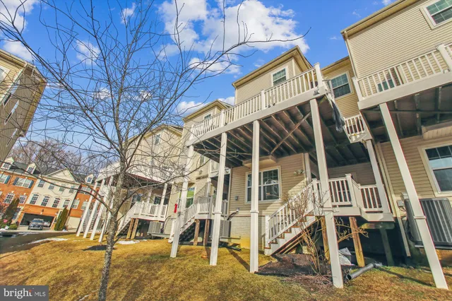 front view of a house with a large tree