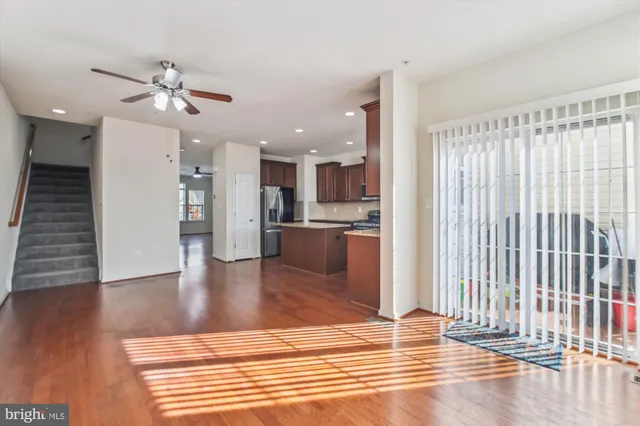 a view of a kitchen with a sink and an entryway