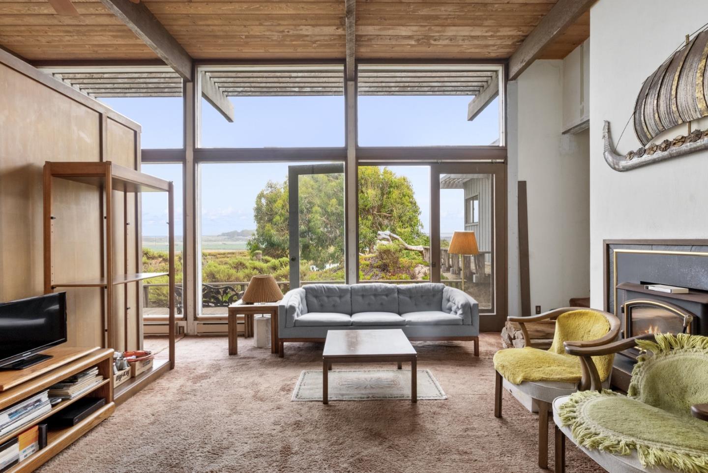 34 Sanderling Circle Watsonville, CA 95076 - Photo 5 of 56 a living room with furniture a flat screen tv and a floor to ceiling window