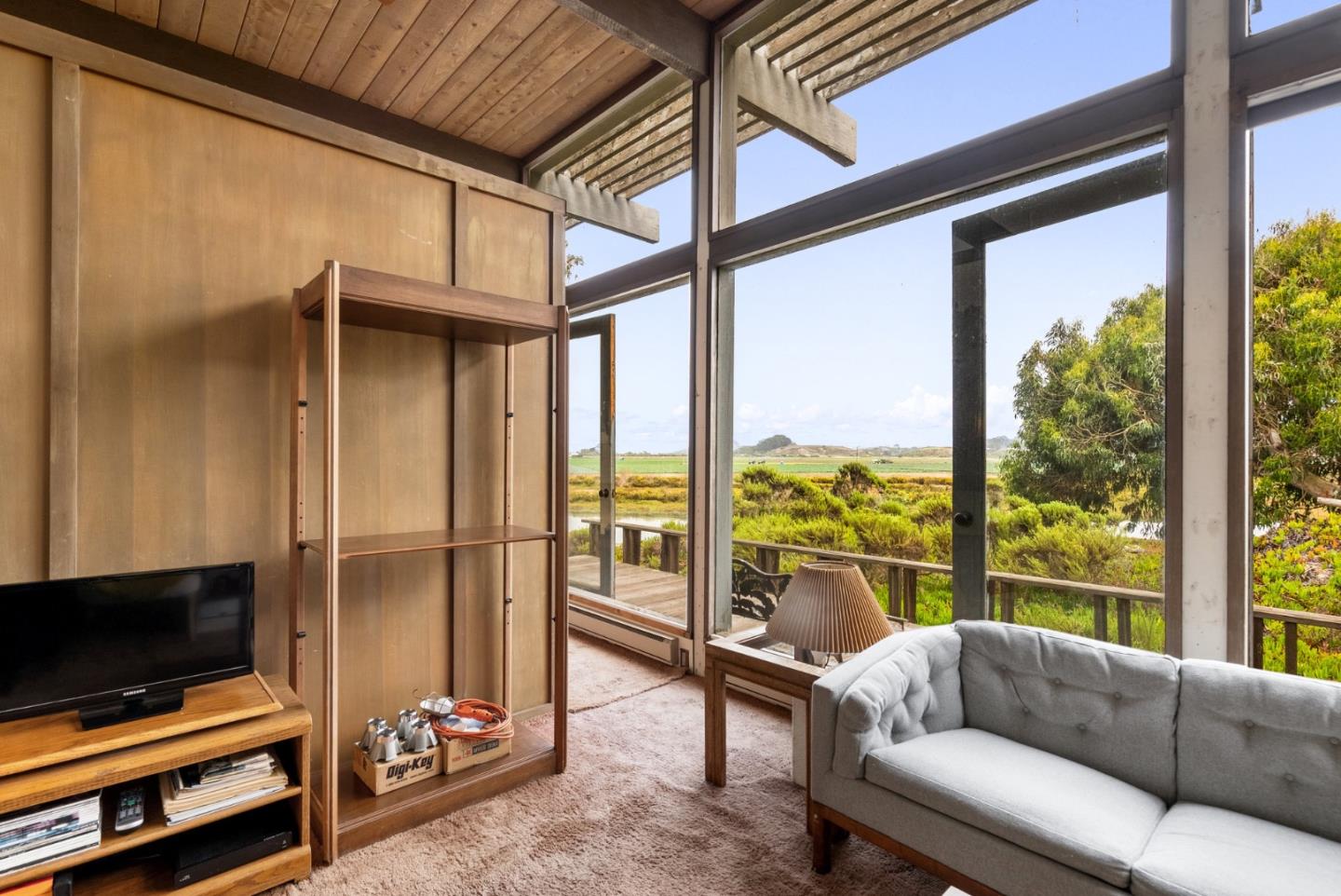 34 Sanderling Circle Watsonville, CA 95076 - Photo 7 of 56 a living room with furniture a flat screen tv and a floor to ceiling window