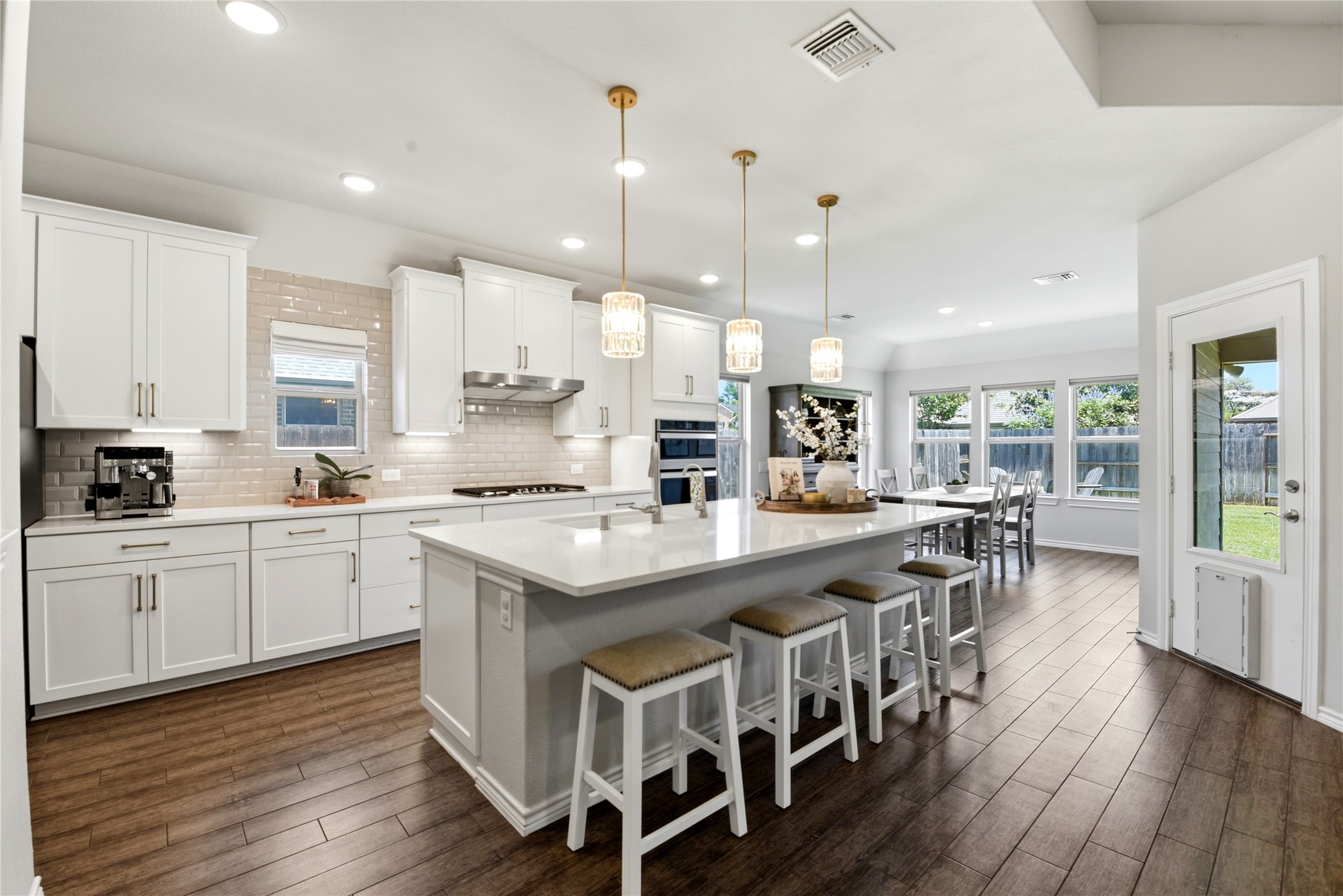17834 Maple Ash Drive Spring, TX 77379 - Photo 1 of 50 Kitchen offers a spacious island with bar seating. The open layout leads to a dining area with large windows overlooking the backyard, providing ample natural light.