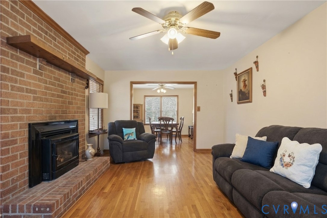 5612 Whitesell Road Louisa, VA 23093 - Photo 11 of 26 a living room with furniture fireplace and a flat screen tv