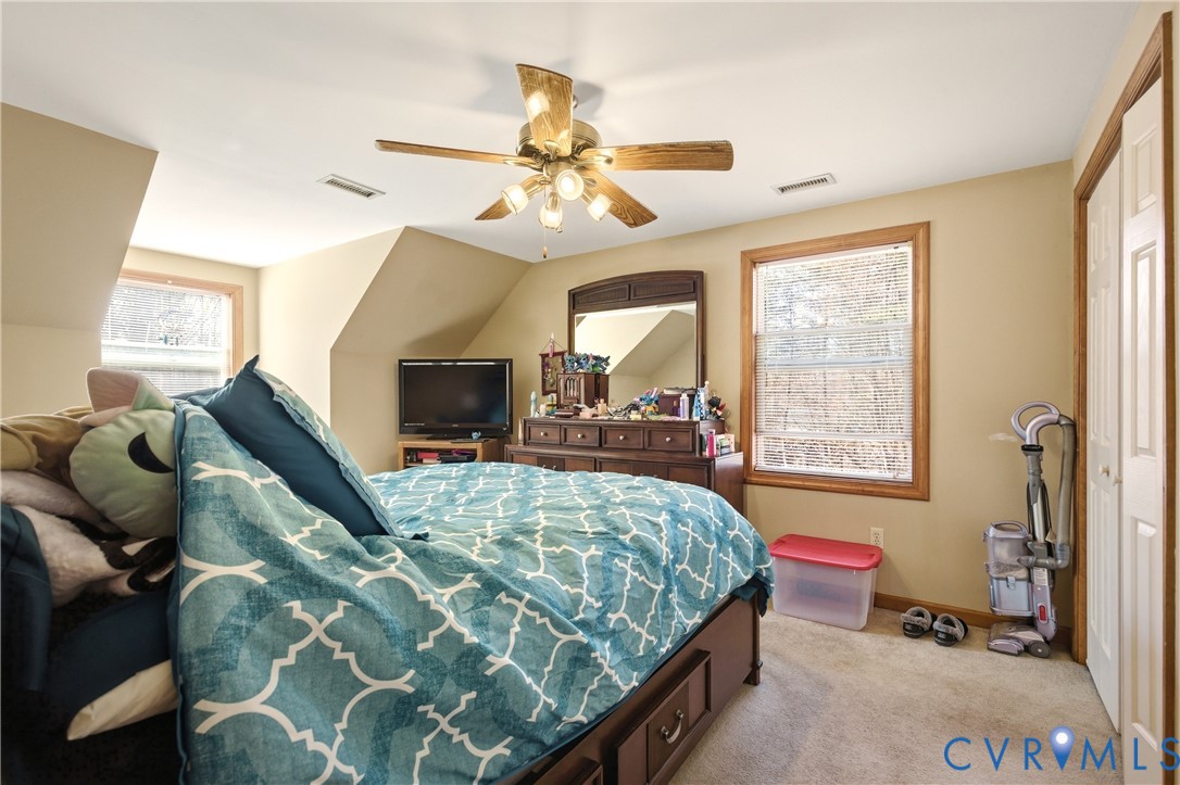 5612 Whitesell Road Louisa, VA 23093 - Photo 13 of 26 a bedroom with a bed and a chandelier