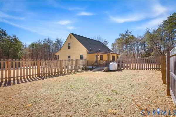 a view of a house with a wooden fence