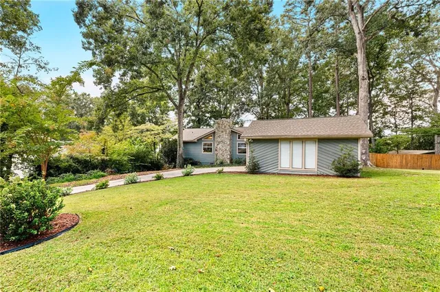 a house with a yard and a large tree
