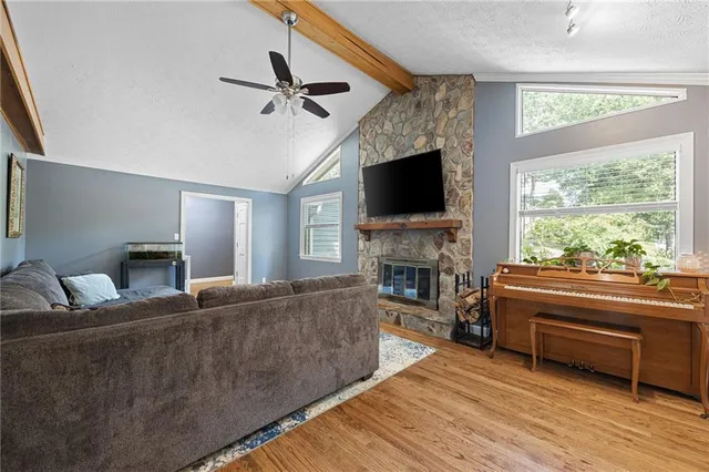 a living room with fireplace furniture and a flat screen tv