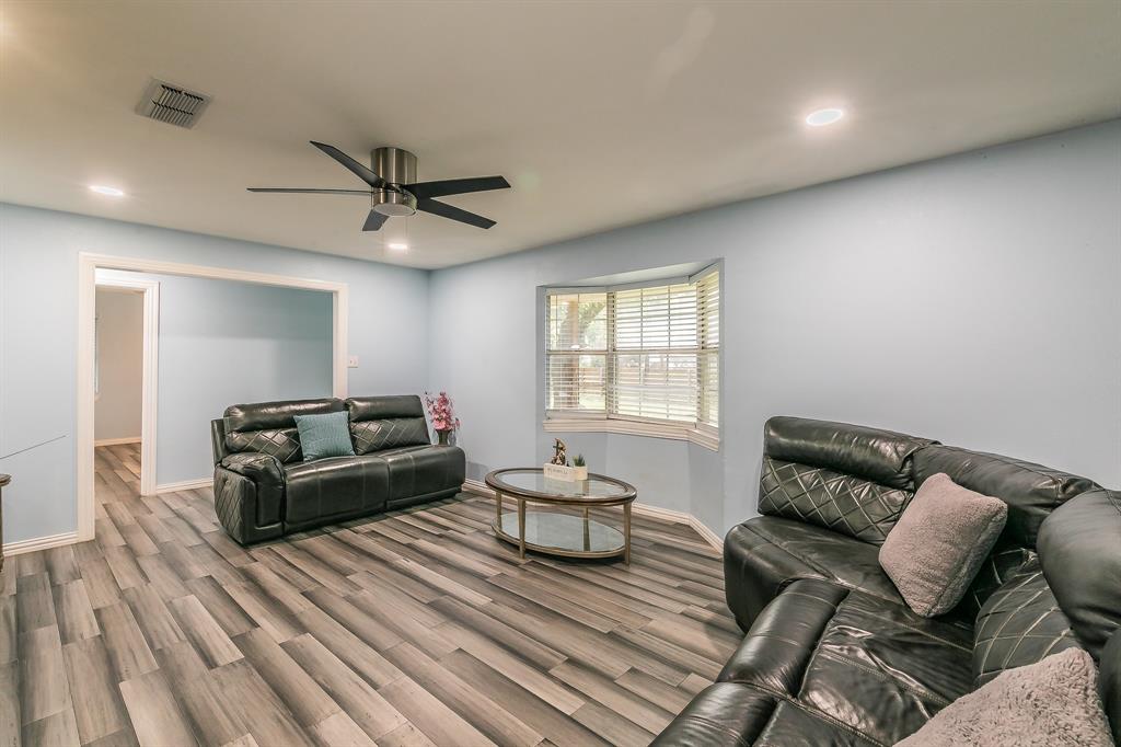 904 Sherman Street Tioga, TX 76271 - Photo 14 of 40 a living room with furniture and a chandelier