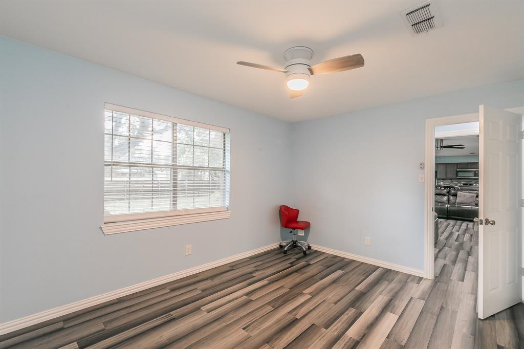 904 Sherman Street Tioga, TX 76271 - Photo 19 of 40 a view of a livingroom with wooden floor and a window