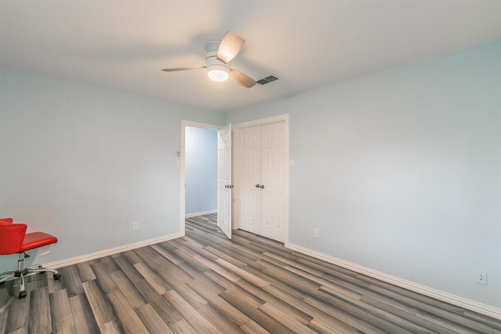 904 Sherman Street Tioga, TX 76271 - Photo 20 of 40 wooden floor in an empty room with a window