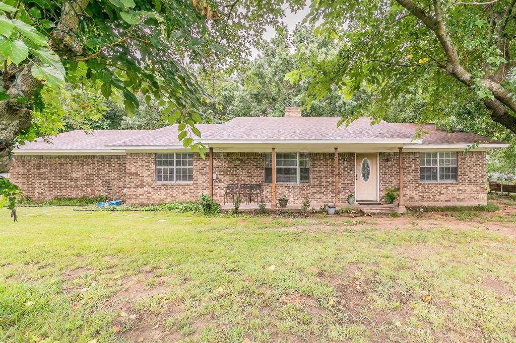 904 Sherman Street Tioga, TX 76271 - Photo 2 of 40 a front view of a house with a garden