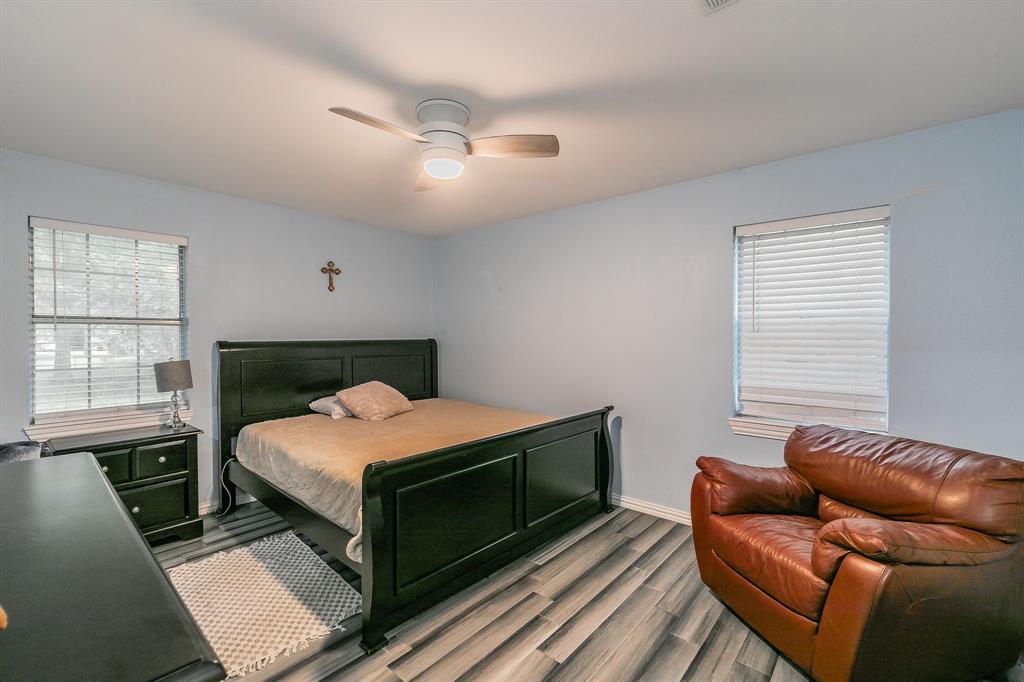 904 Sherman Street Tioga, TX 76271 - Photo 23 of 40 a bedroom with a bed couch and window