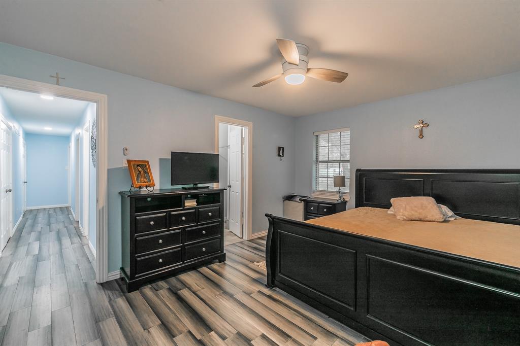 904 Sherman Street Tioga, TX 76271 - Photo 24 of 40 a bedroom with a bed and flat screen tv