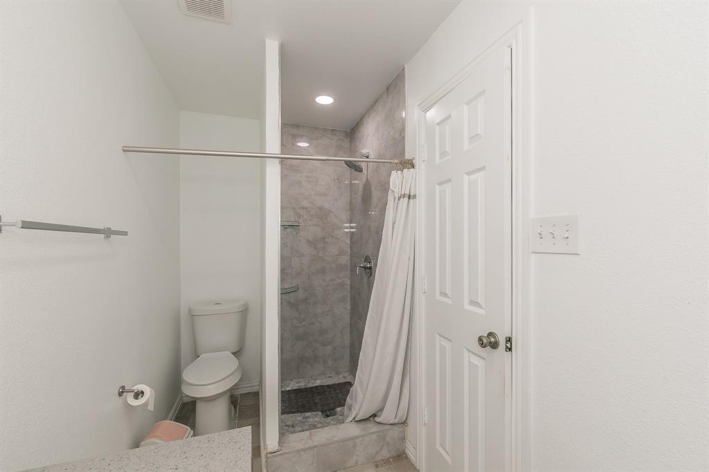 904 Sherman Street Tioga, TX 76271 - Photo 27 of 40 a bathroom with a toilet and a shower