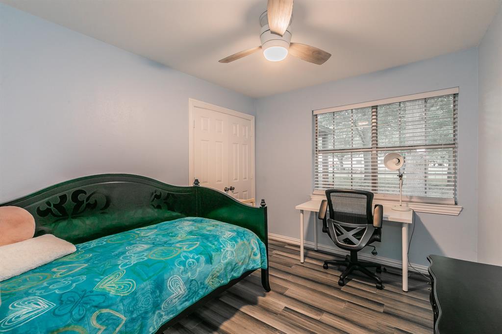 904 Sherman Street Tioga, TX 76271 - Photo 30 of 40 a bedroom with a bed a desk and chair