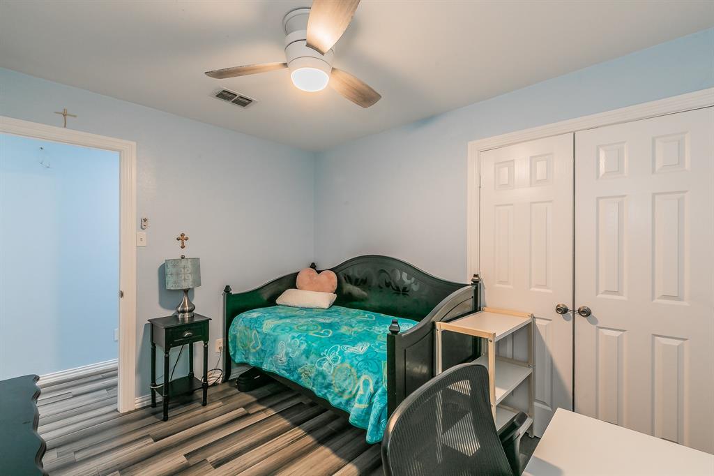 904 Sherman Street Tioga, TX 76271 - Photo 31 of 40 a bedroom with a bed and wooden floor