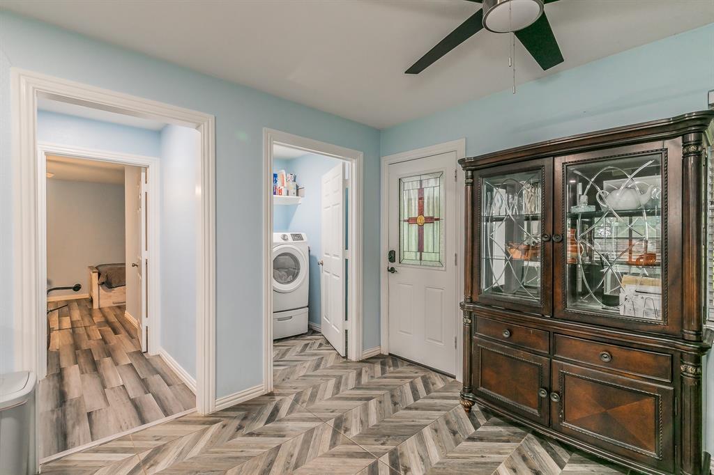 904 Sherman Street Tioga, TX 76271 - Photo 37 of 40 a view of a hallway and a livingroom with wooden floor windows