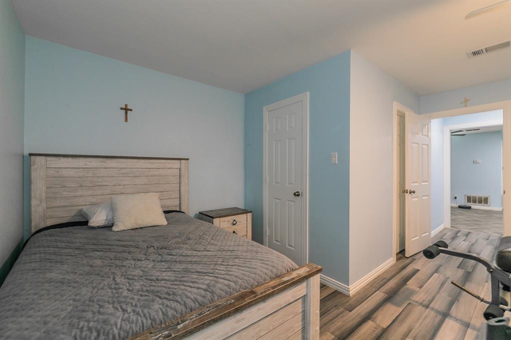 904 Sherman Street Tioga, TX 76271 - Photo 40 of 40 a bedroom with a bed and a large mirror